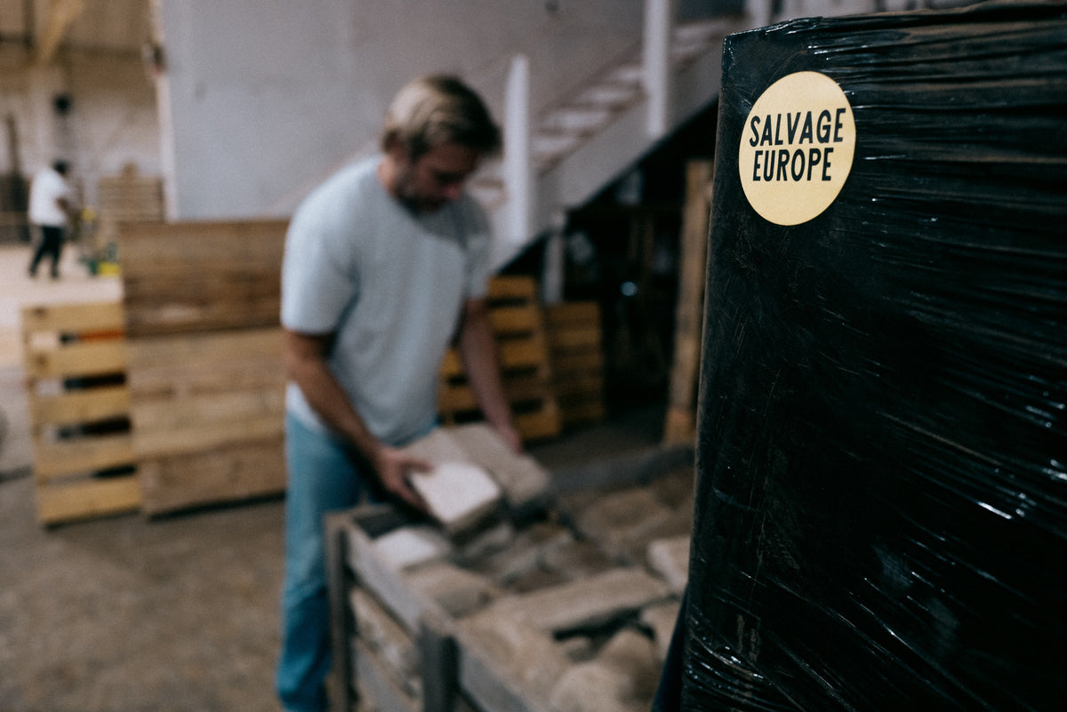 Salvage Europe team member sorting reclaimed stone in the Los Angeles warehouse