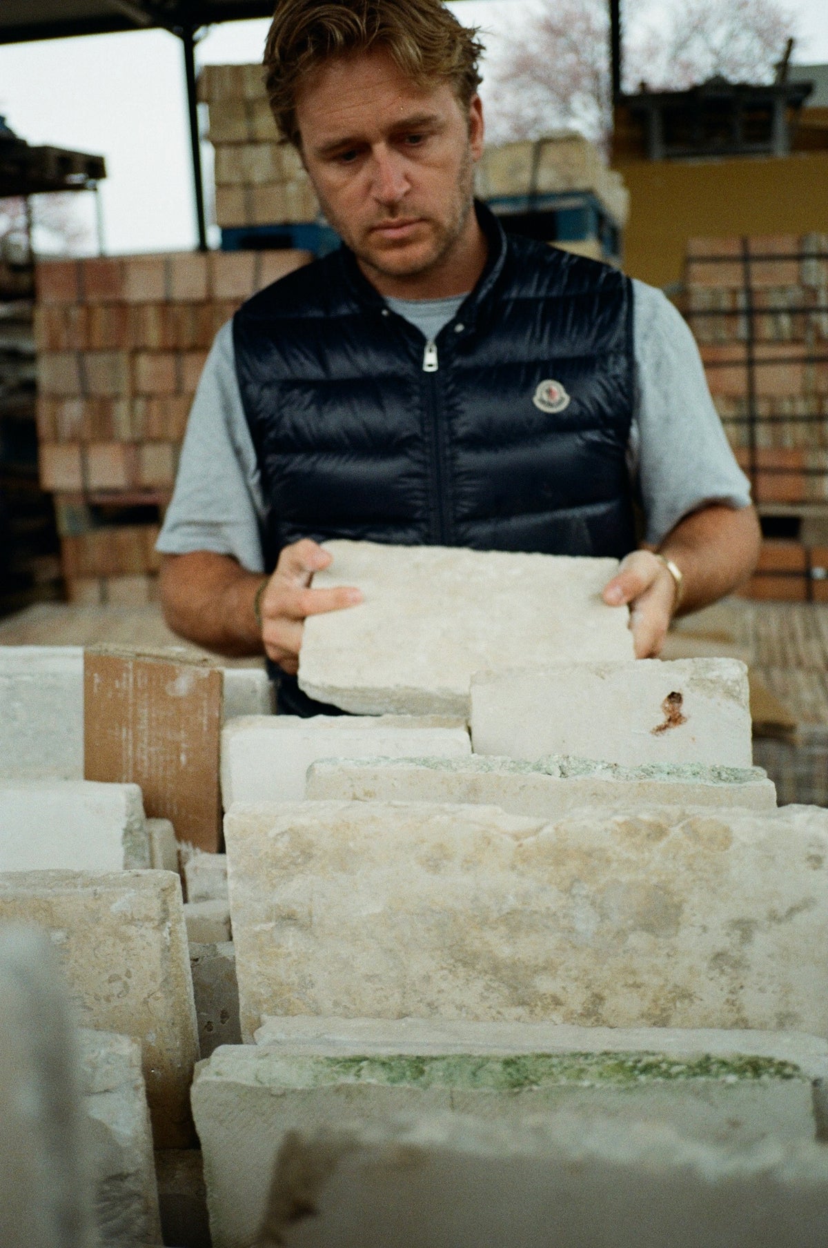 Evan selecting reclaimed limestone at a stone yard in Europe