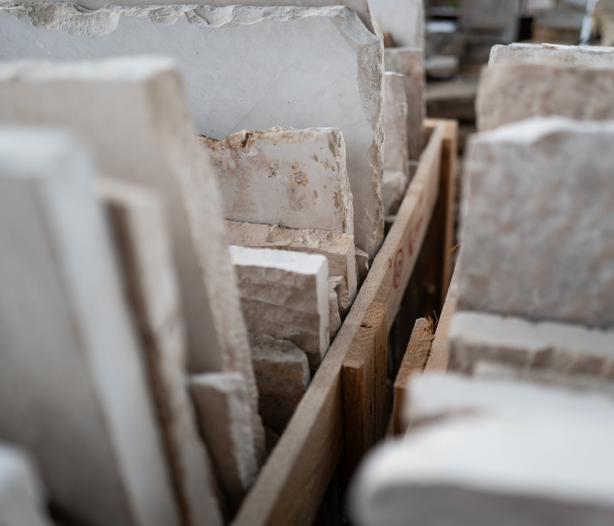 Reclaimed limestone pieces packed in a timber crate