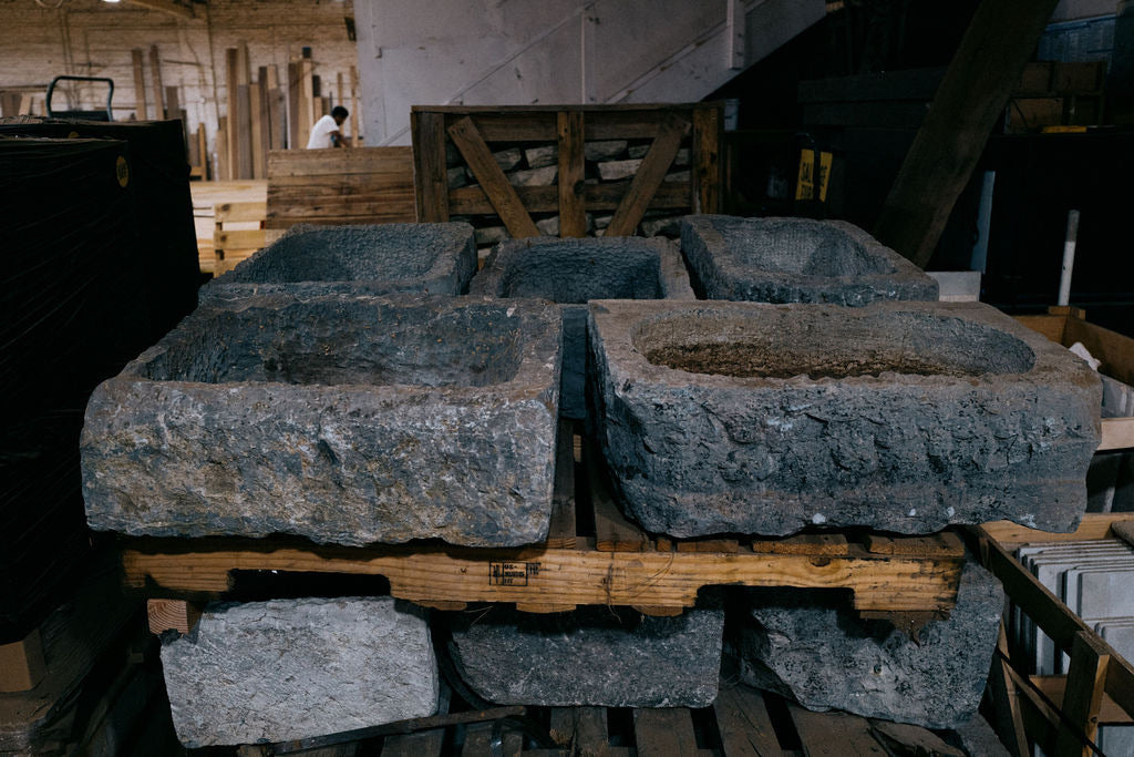 Antique hand-carved Belgian bluestone troughs in the Los Angeles warehouse