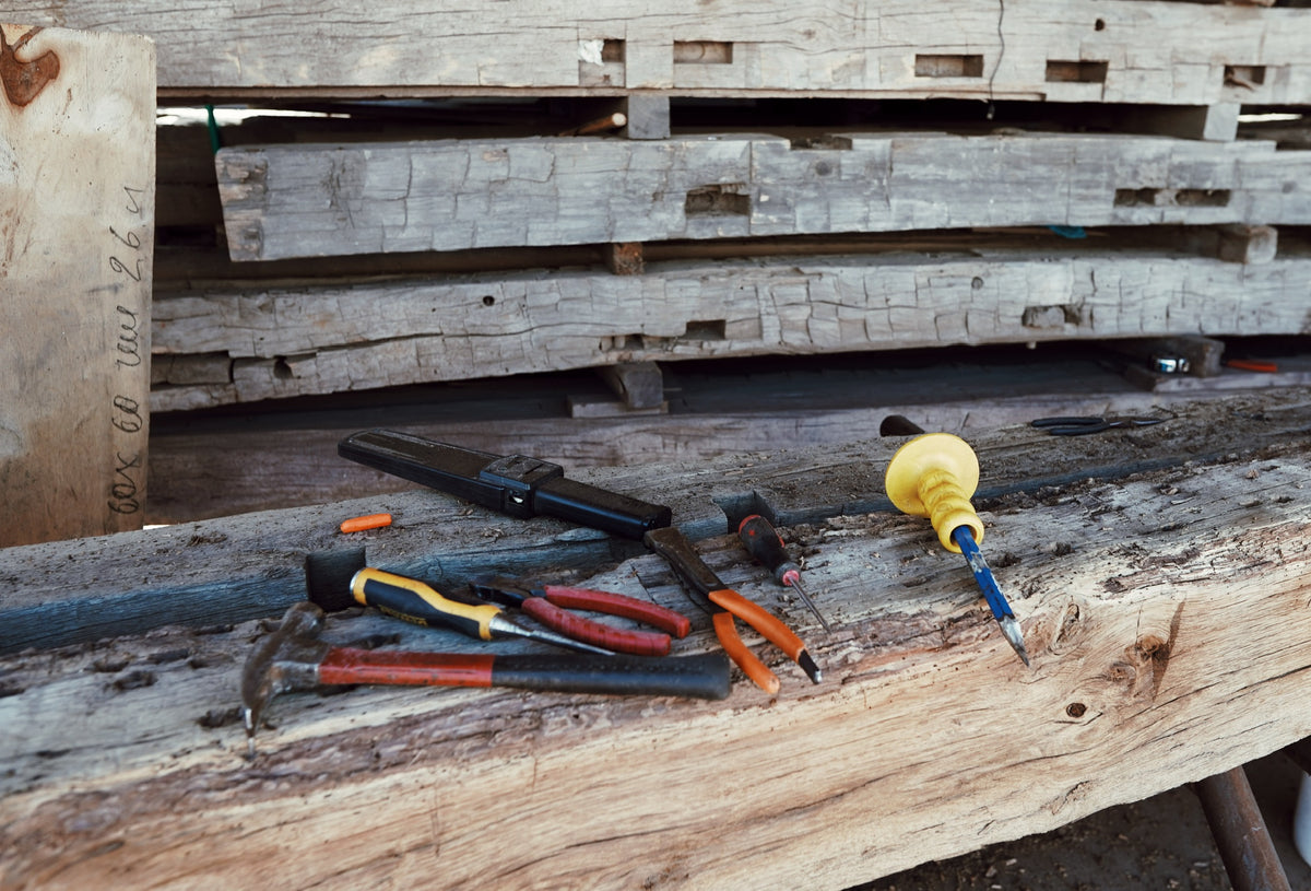 Hand hewn reclaimed oak beam being prepared in the yard