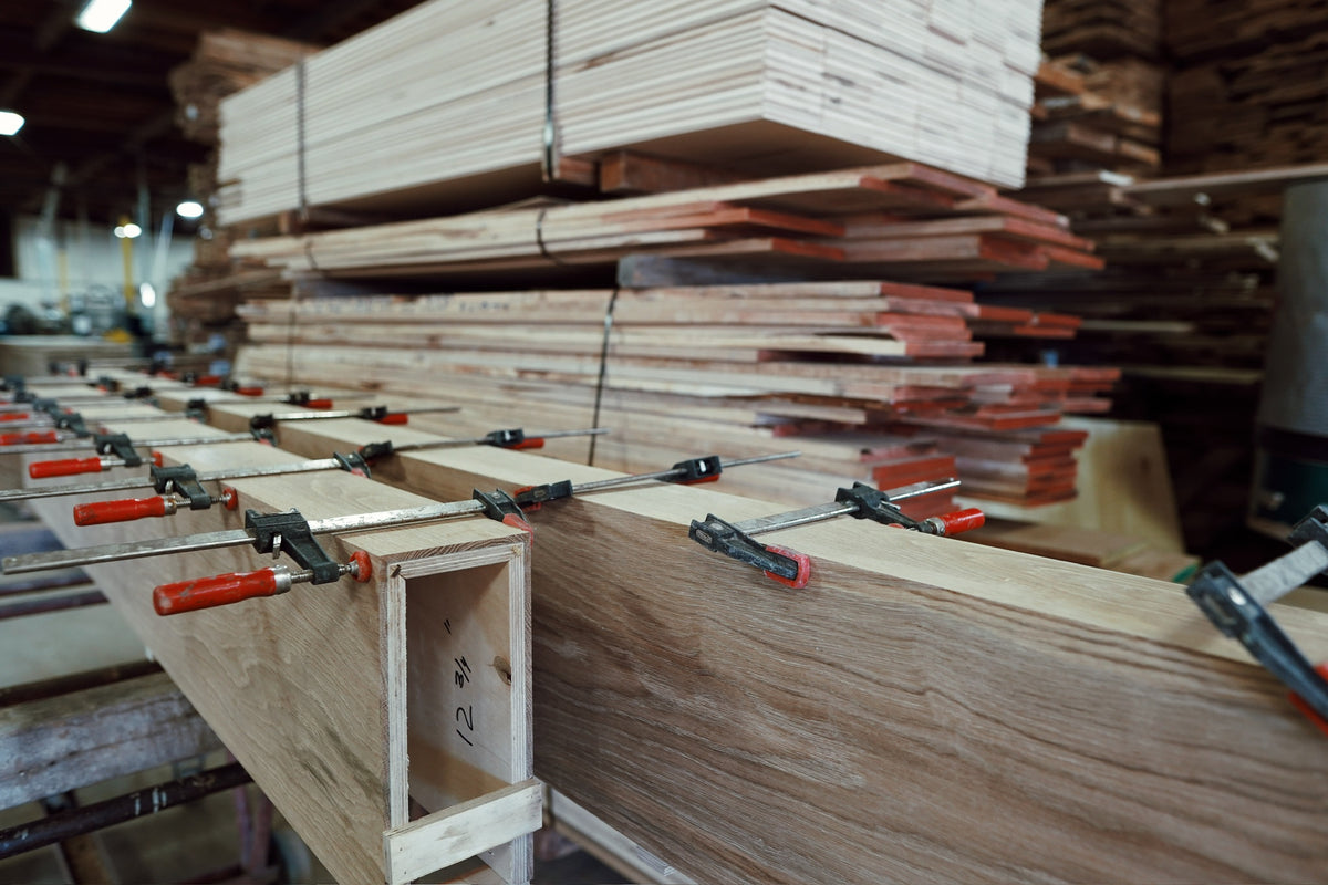 Old growth French oak box beams clamped during glue-up