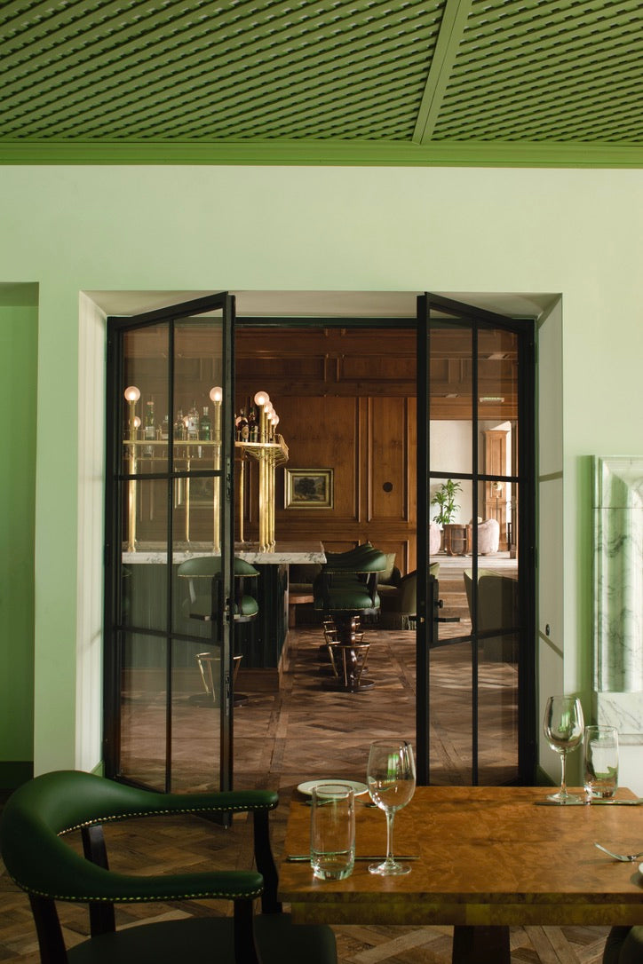 Versailles panel floor in green room with bar beyond