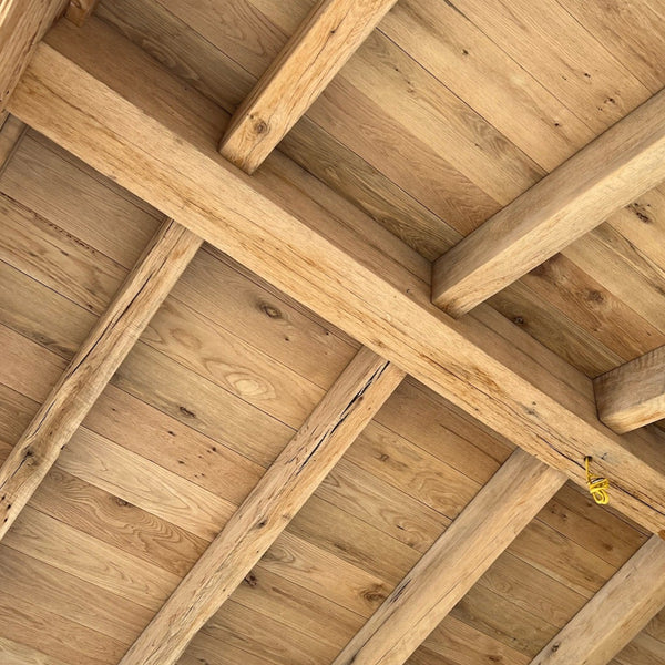 Resawn reclaimed American oak beams showcasing rustic texture and unique grain patterns.