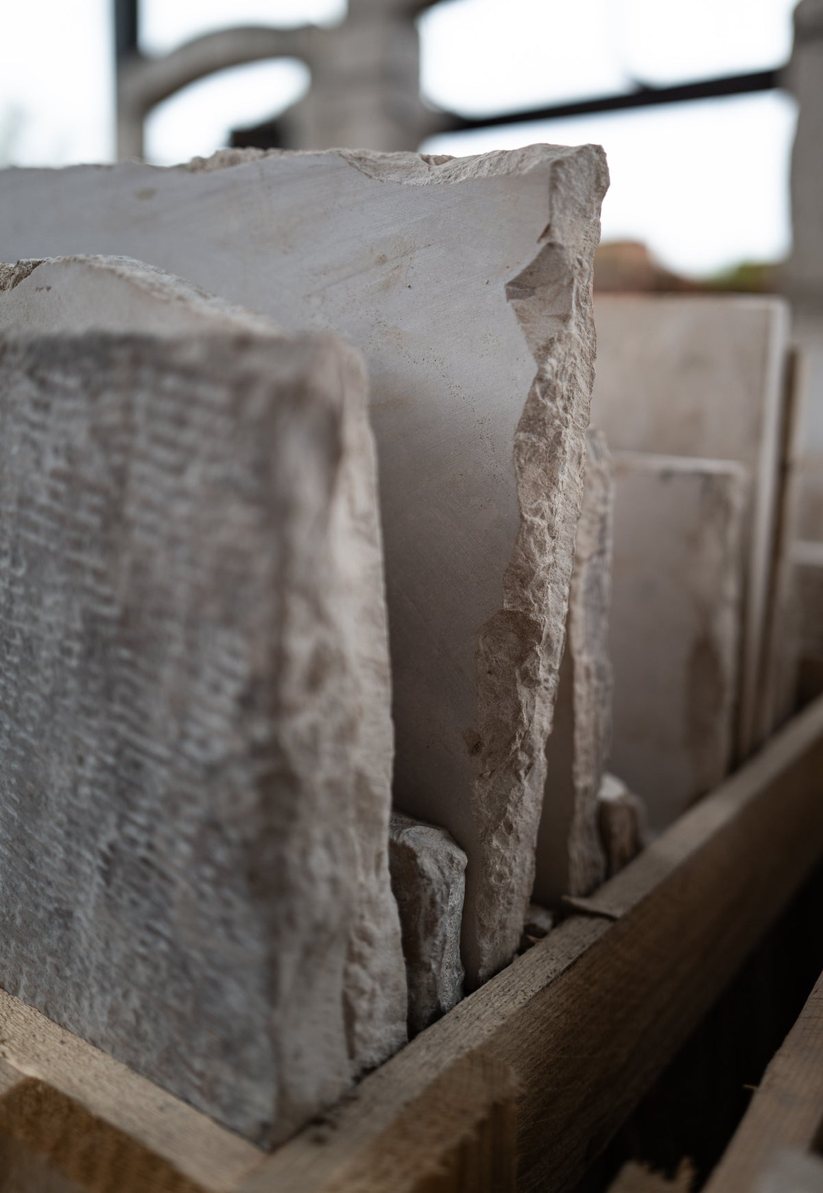 Hand-tooled edge of a reclaimed limestone slab