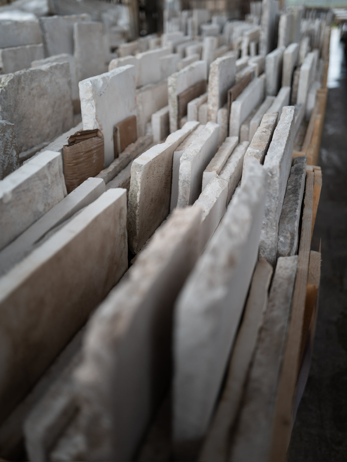 Long rows of reclaimed limestone in the yard
