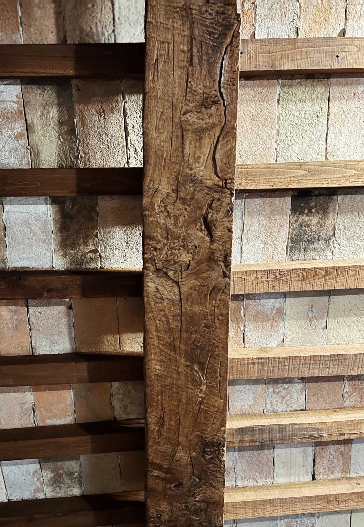 Hand-hewn oak beam with joists and terracotta ceiling tiles