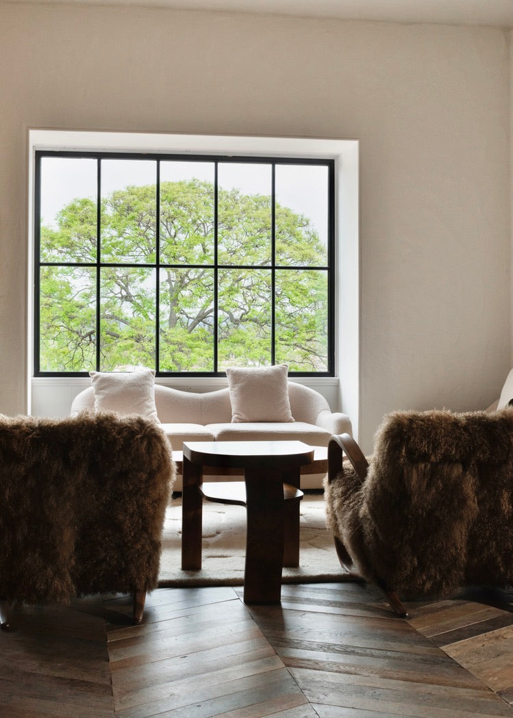 Haussmann chevron oak floor with sheepskin chairs