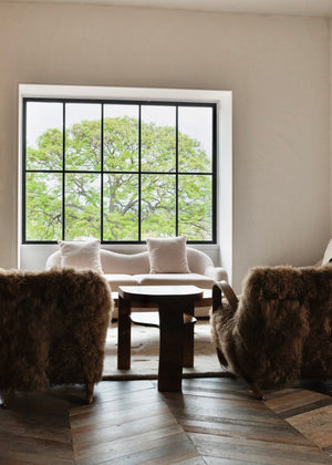 Haussmann chevron oak floor with sheepskin chairs