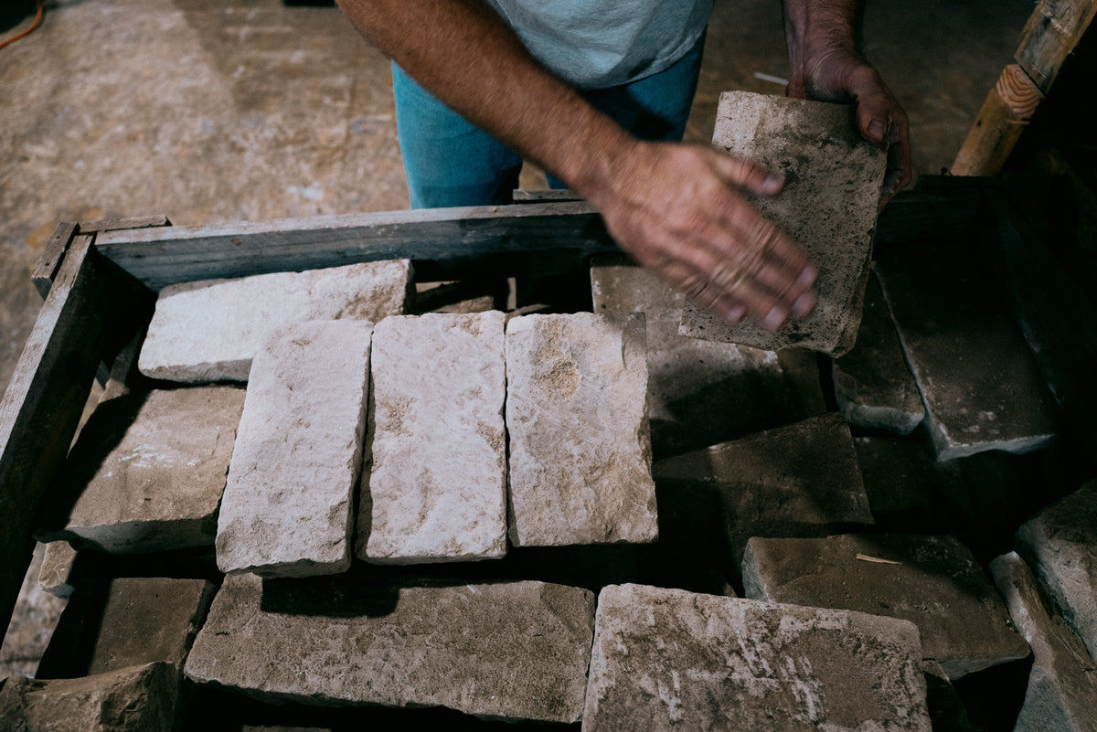 Reviewing Dalle de Bourgogne limestone pieces by hand