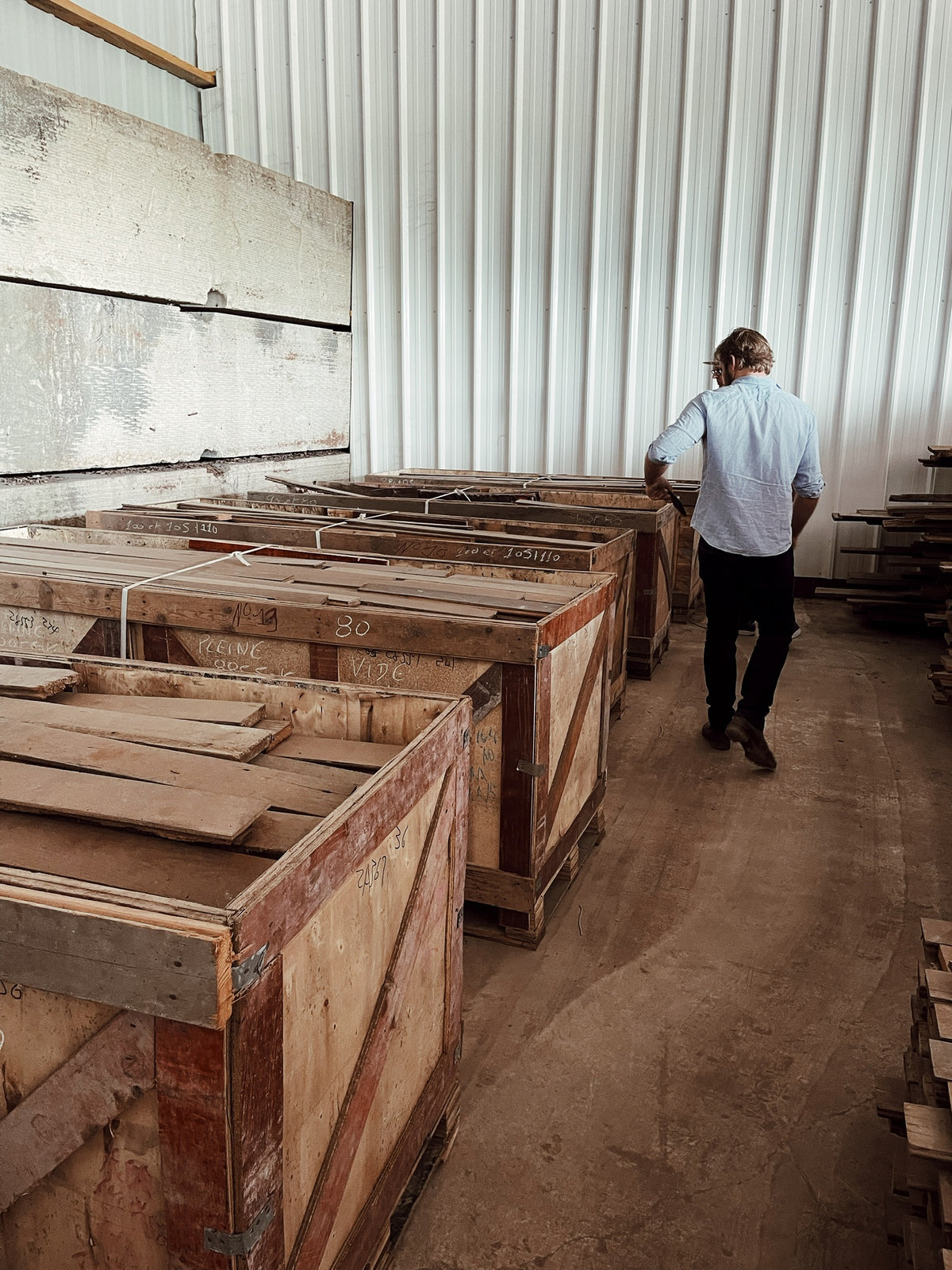 Crates of reclaimed Haussmann oak chevron at the source warehouse