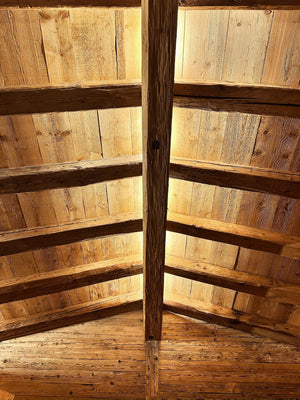 Reclaimed pine ceiling boards between rafters