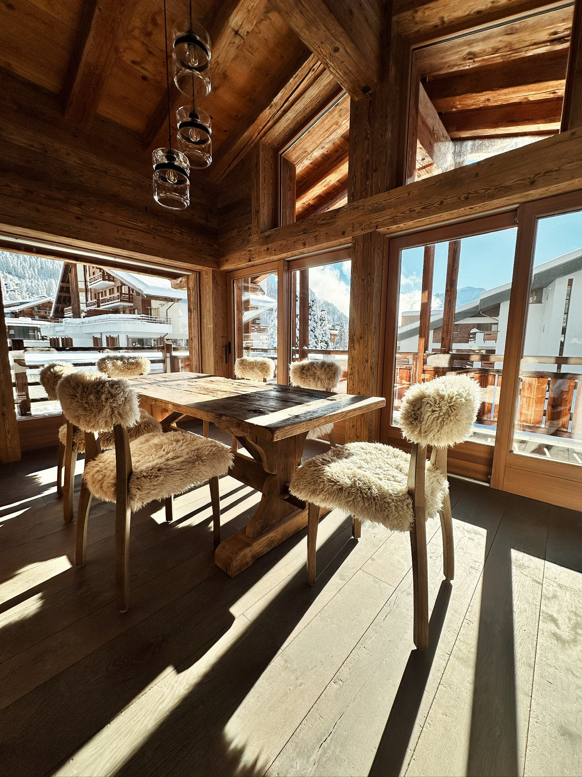 Chalet dining room framed in reclaimed pine beams