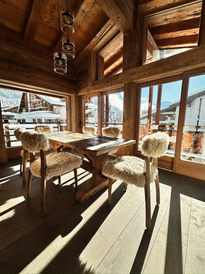 Reclaimed pine cladding and beams in a sunlit chalet