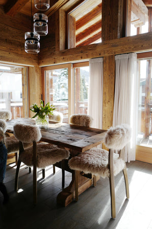 Chalet dining room with reclaimed pine walls and beams