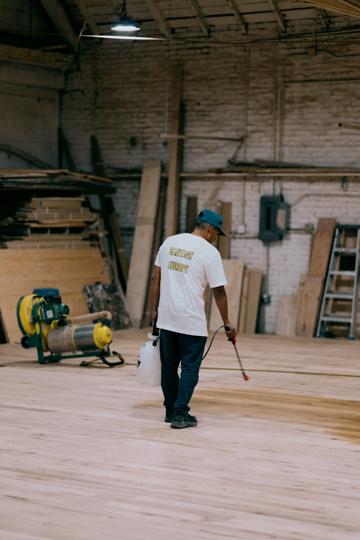 Finishing a laid-out reclaimed French oak floor at the Salvage Europe workshop in Los Angeles